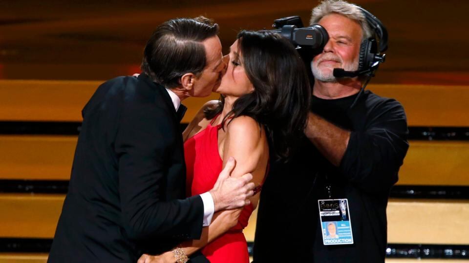 Actor Bryan Cranston engages Julia Louis-Dreyfus in a prolonged kiss as she takes the stage to accept the award for for Outstanding Lead Actress In A Comedy Series for her role in HBO’s Veep. Photograph: Mario Anzuoni/Reuters