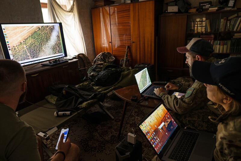 A Ukrainian drone pilot and his navigator review footage of the moment when a Russian missile flew by their drone from a position in the Zaporizhzhia region of Ukraine. Photograph: Lynsey Addario/The New York Times