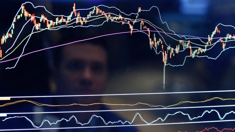 A trader is reflected in his screen on the floor of the New York Stock Exchange (NYSE) at the start of the trading day in New York. Photograph: EPA/ANDREW GOMBERT