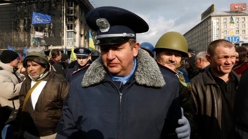 Terror reigns: a police officer who has joined anti-government protesters at a rally in Independence Square in Kiev. February 21, 2014. Photograph: Yannis Behrakis/Reuters