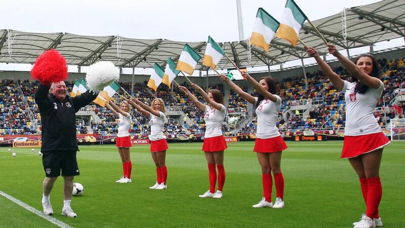 Republic of  Ireland kit man Dick Redmond and cheerleaders lead the team out at an open training session in Gydnia, Poland, during Euro 2012. Photograph: Donall Farmer / Inpho