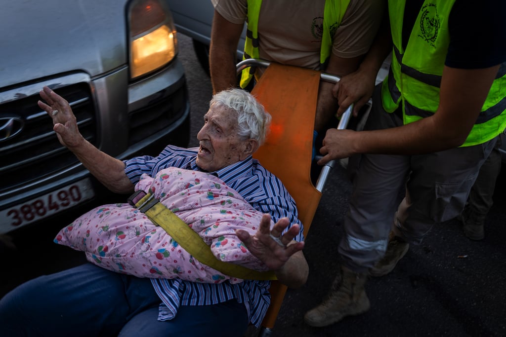 An elderly man displaced from southern Lebanon arrives by ambulance at the Technical School of Bir Hassan in Beirut, Lebanon Photograph: The New York Times
