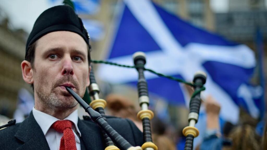 Playing bagpipes in George Square, Glasgow. Photograph: Jeff J Mitchell/Getty Images