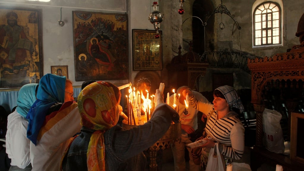 Christian pilgrims light candles inside the Church of Nativity, believed by many to be the birthplace of Jesus Christ, in Bethlehem. Photograph: AP Photo/Nasser Shiyoukhi