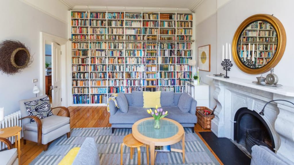 The living room to the rear of 54 Kenilworth Square in Rathgar basks in southerly light and features a wall of tightly packed bookshelves with a hanging library ladder.