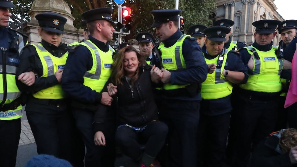 Gardaí remove demonstrators during an Extinction Rebellion protest on the day of the Irish budget outside Leinster House. Photograph: Liam McBurney/PA