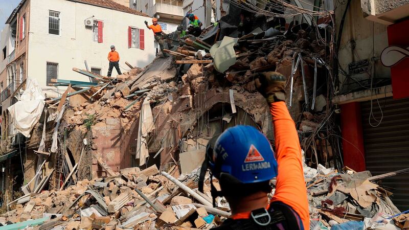 Rescue workers dig through the rubble of a badly damaged building in Lebanon’s capital Beirut. Photograph: Joseph Eid/AFP via Getty Images