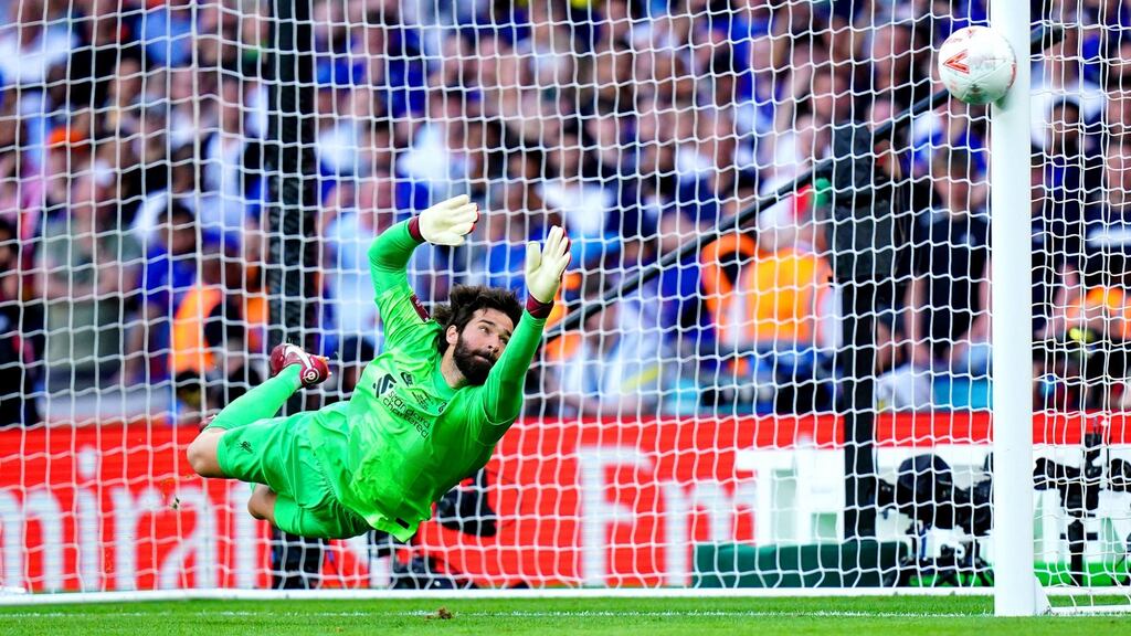 Liverpool goalkeeper Alisson dives as a penalty from Chelsea’s Cesar Azpilicueta (not pictured) hits the post. Photograph: Adam Davy/PA Wire
