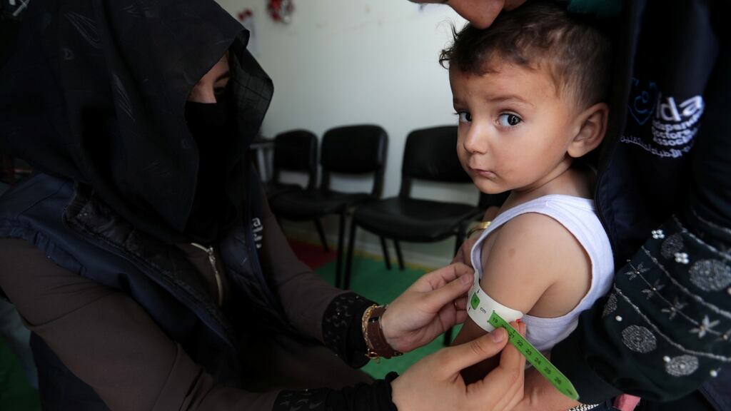 A paediatrician measures a child at a mobile clinic in north Azaz, Syria. Photograph: Khalil Ashaw/Reuters