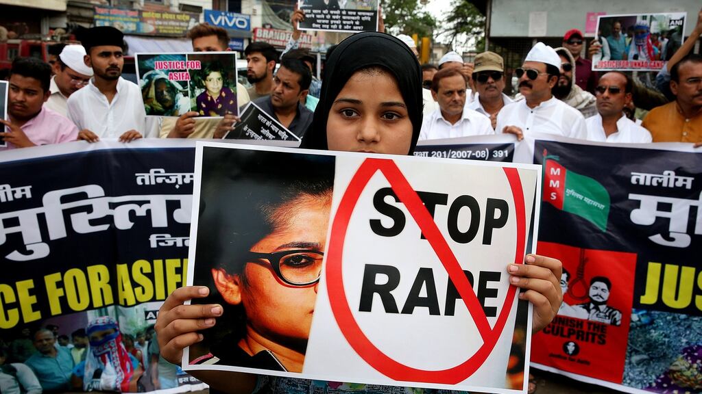 A girl holds a banner as Indian activists hold placards that read in Hindi ‘Indian Government take stern action against the rapists’ during a protest against the alleged rape cases, in Bhopal, India. Photograph: Sanjeev Gupta/EPA