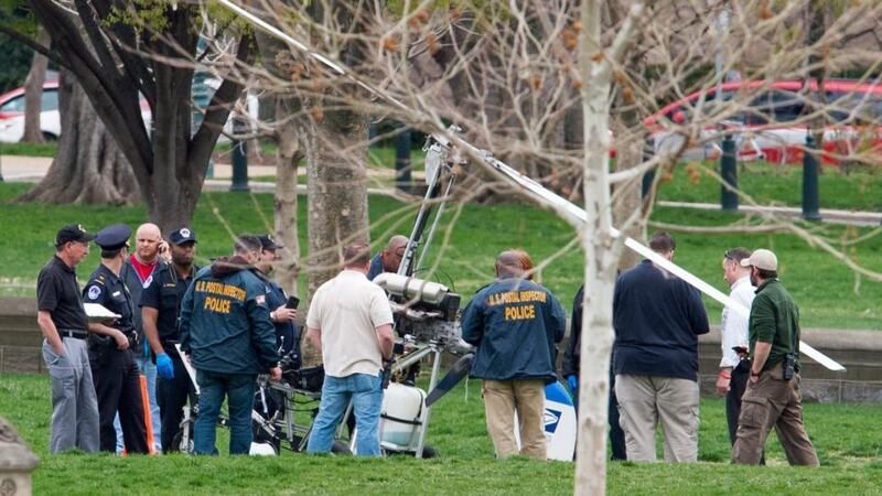 Officials examine the aircraft after it was declared safe. The tail of the aircraft was emblazoned with the US Postal Service logo. Photograph: Paul J Richards/AFP