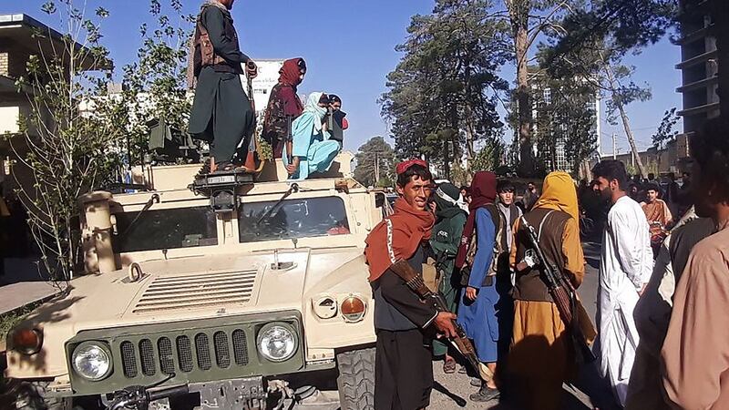 Taliban fighters stand guard along the roadside in Herat, Afghanistan’s third biggest city, on Friday, after government forces pulled out the day before. Photograph: AFP via Getty Images