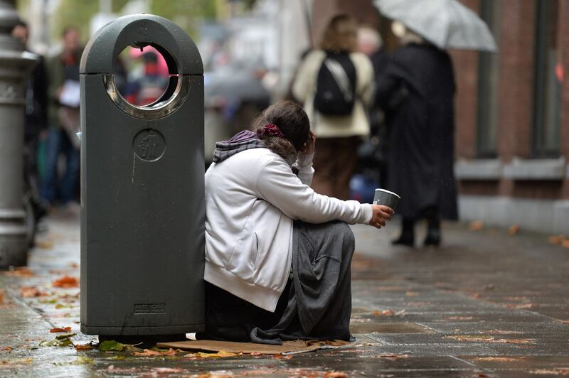 A young woman with a paper cup begging in Dublin city centre.
photograph: cyril byrne