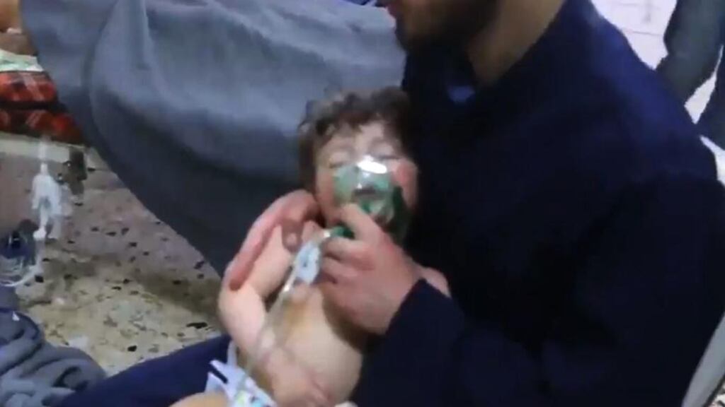 An image grab taken from a video released by the Syrian civil defence in Douma shows an unidentified volunteer holding an oxygen mask over a child’s face at a hospital following a reported chemical attack on  April 8th, 2018. Photograph: HO/AFP/Getty Images
