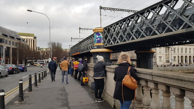 Dubliners gathered on Butt bridge to watch the dolphon. Photograph: Paddy Logue