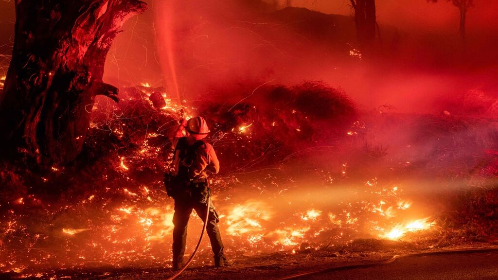 A firefighter douses flames from a backfire during the Maria fire in Santa Paula, California on November 1st. Photograph: Josh Edelson/AFP