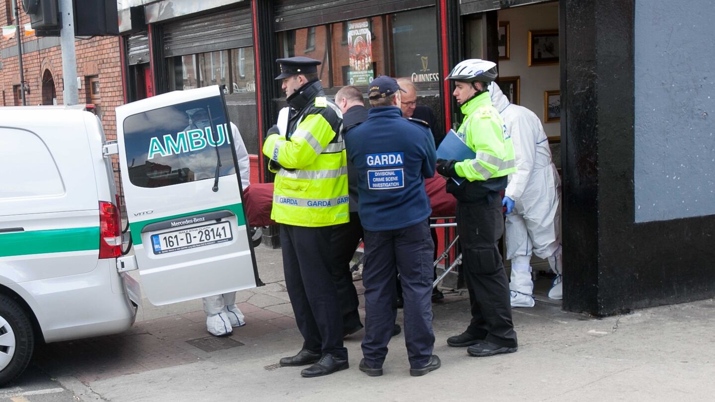 Gardai with the remains of a Michael Barr  who shot dead   at the Sunset House pub in Summerhill, in Dublin on Monday. Photograph: Collins
