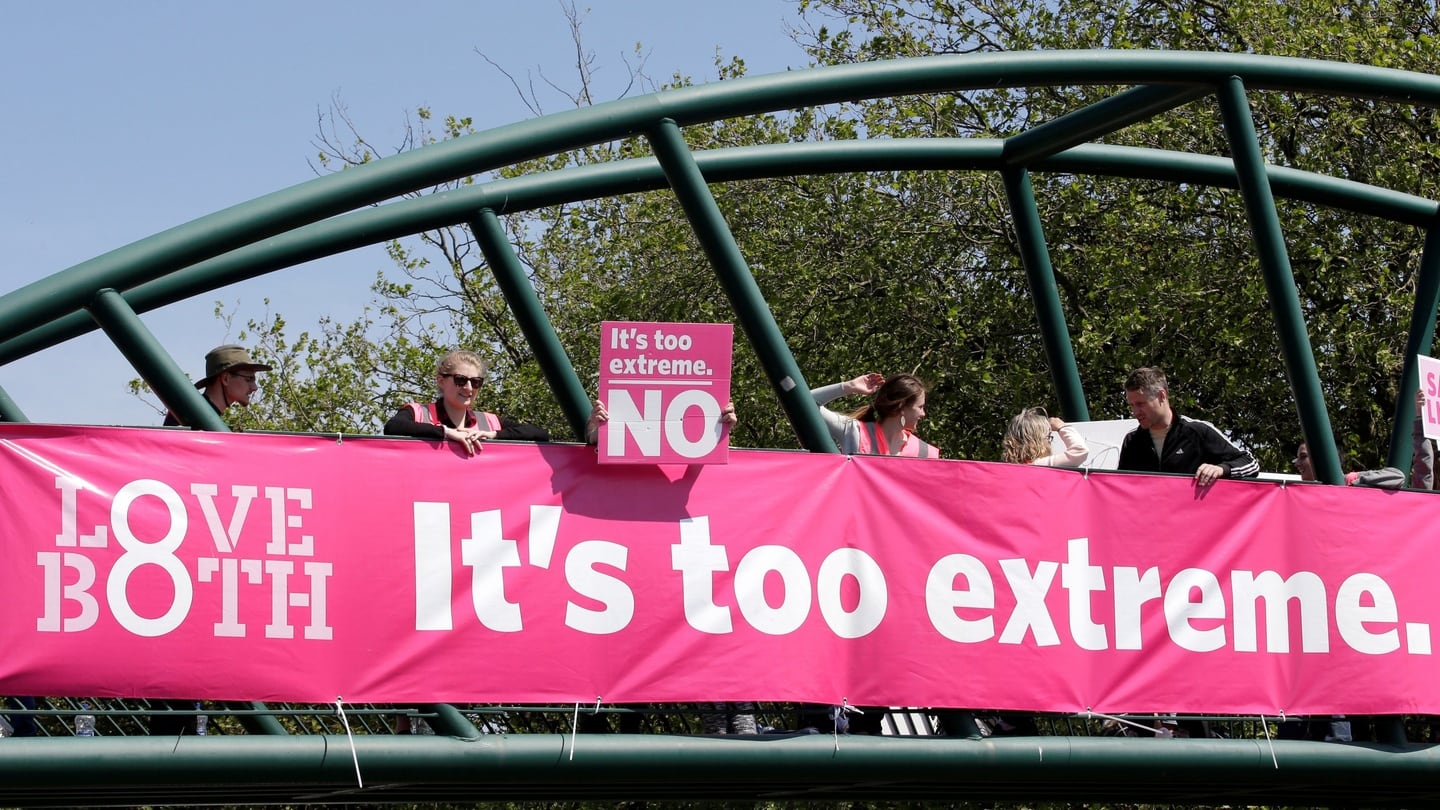 Campaigners hold up banners to persuade voters in Dublin to retain the Eighth Amendment as polls open in the referendum on the issue. Photograph: Max Rossi/Reuters