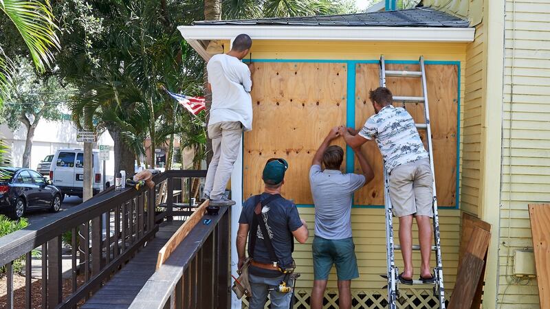 Employees of the Island Root Kava Lounge board up the windows of the business in preparation for Hurricane Dorian in Melbourne, Florida. Photograph: Zack Wittman/Bloomberg