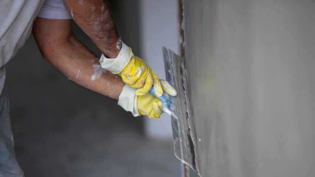 A plasterer at work. Photograph: Krisztian Bocsi/Bloomberg