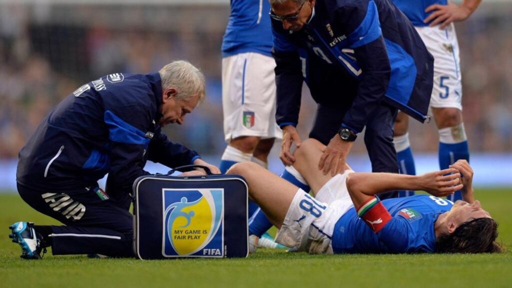 Italy’s Riccardo Montolivo receives medical attention after breaking his leg at Craven Cottage last night. Photograph: Toby Melville/Reuters