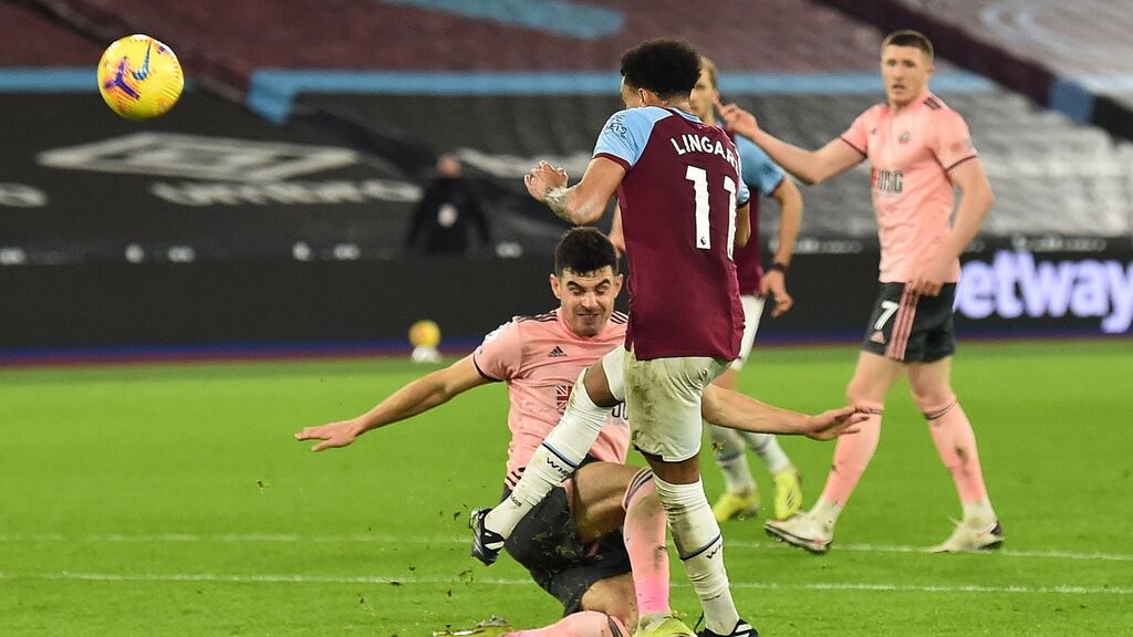 Sheffield United’s Irish defender John Egan suffered an injury during this challenge on West Ham’s Jesse Lingard during the Premier League game at London stadium. Photograph: Glyn Kirk/AFP via Getty Images