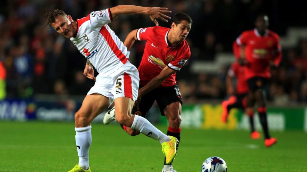 Millton Keynes Dons’ Antony Kay tussles with Manchester United’s Javier Hernandez during the Capital One Cup Second Round match at Milton Keynes. Photograph: Nick Potts/PA Wire.