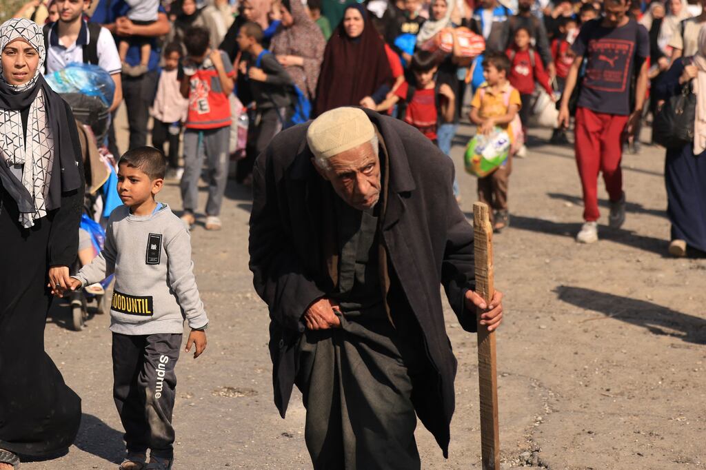 Palestinian families fleeing Gaza City and other parts of northern Gaza walk along a road towards the south of the enclave on Friday. Photograph: Mahmud Hams/AFP via Getty Images