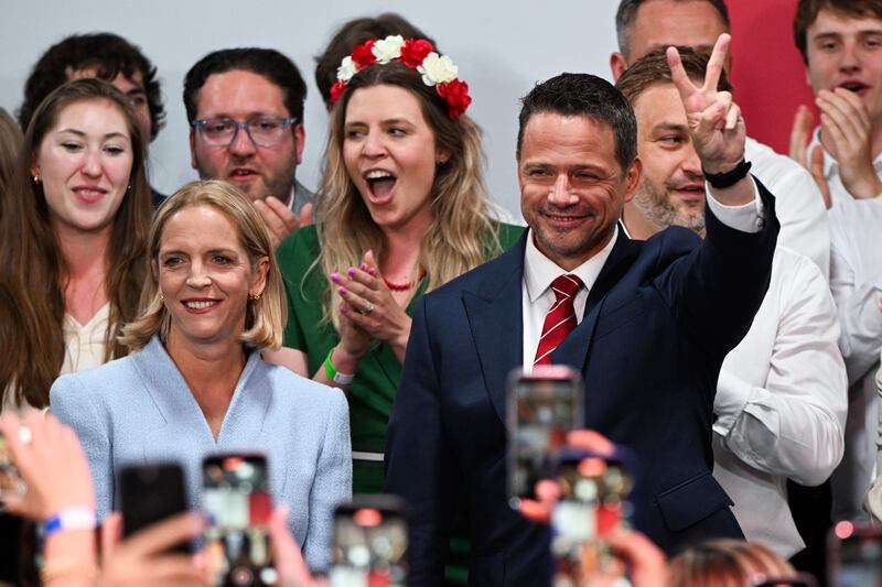 Rafal Trzaskowski and wife, Malgorzata, celebrate the exit poll results during the runoff of the presidential election. Photograph: Omar Marques/Getty