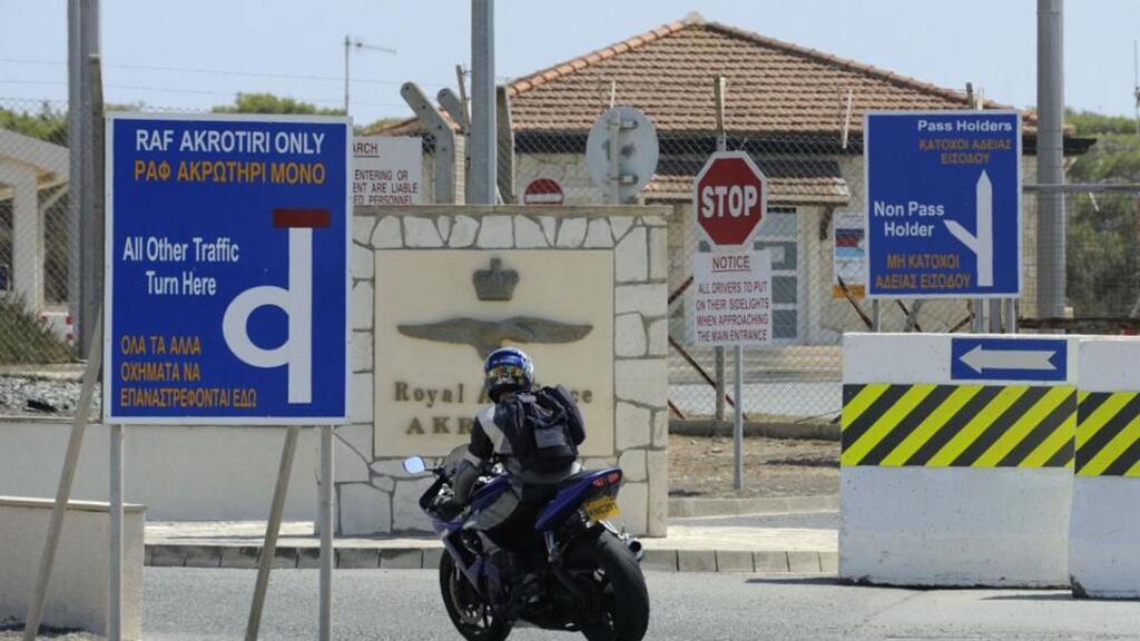 A man rides a motorcycle through the gates at Akrotiri RAF air base near Limassol, Cyprus, yesterday. Photograph: Pavlos Vrionides/AP