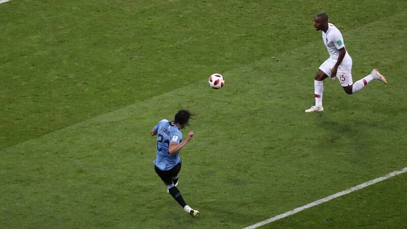 Uruguay’s Edinson Cavani sweeps home his  second goal. Photograph: Sergio Perez/Reuters