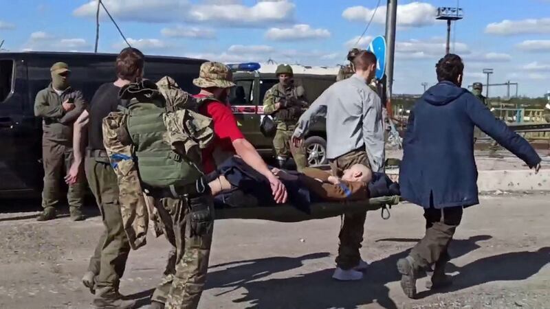 This screen grab obtained from a handout video released by the Russian defence ministry shows a Ukrainian service member escorted by pro-Russian military personnel after leaving the besieged Azovstal steel plant in Ukraine’s port city of Mariupol. Photograph: Handout/Russian Defence Ministry/AFP