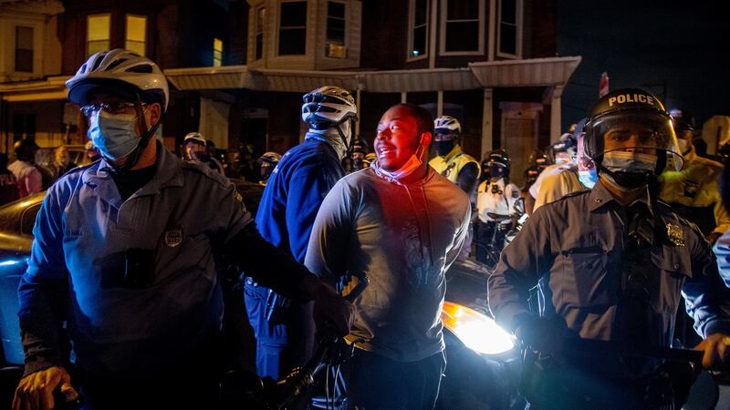 A man is handcuffed and detained by police in Philadelphia on Wednesday, after the citywide curfew had passed, two days after Walter Wallace jnr was killed by police officers. Photograph: Tom Gralish/The Philadelphia Inquirer via AP