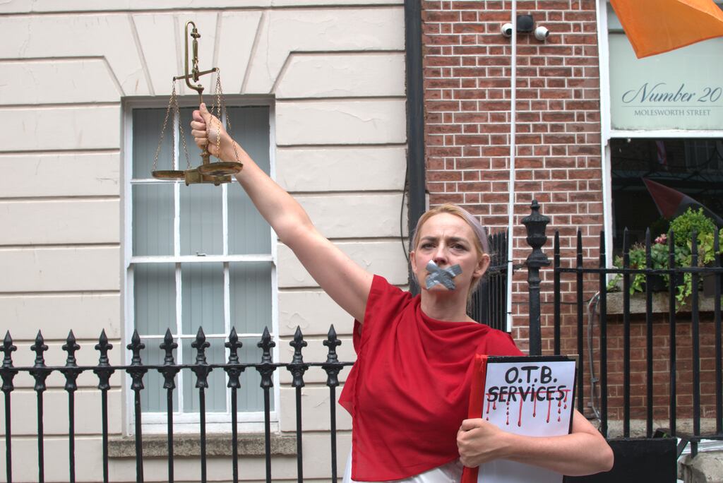 An artist, identifying herself as 'The Refusal Art', with tape over her mouth in protest against the Government not including services in the Occupied Territories Bill, during a pro-Palestinian rally in Dublin calling on the Government to implement sanctions against Israel.  Photograph: PA