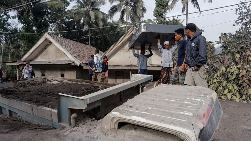 A truck buried under volcanic ash from the Mount Semeru eruption. Photograph: Ammar/EPA