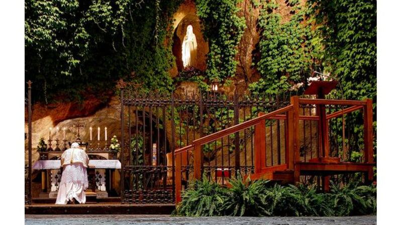 Pope Benedict praying at the Lourdes grotto. photographs: claudio peri/afp/getty and franco origlia/getty