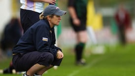 Why is it so unusual for a woman to manage a camogie team?
