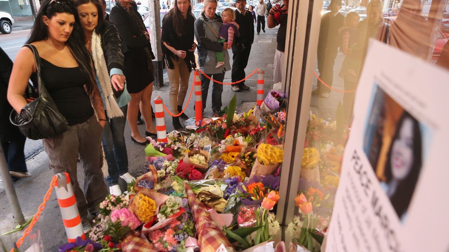 People look at floral tributes outside the front of the Duchess Boutique on Sydney Rd, the store which captured the last CCTV footage of Jill Meagher on September 28th, 2012 in Melbourne, Australia. Photograph: Scott Barbour/Getty Images