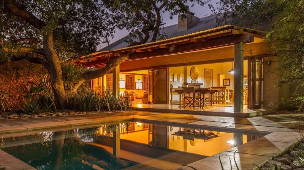 South Africa: the livingroom of this lodge opens via a disappearing wall on to hardwood decking and a pool