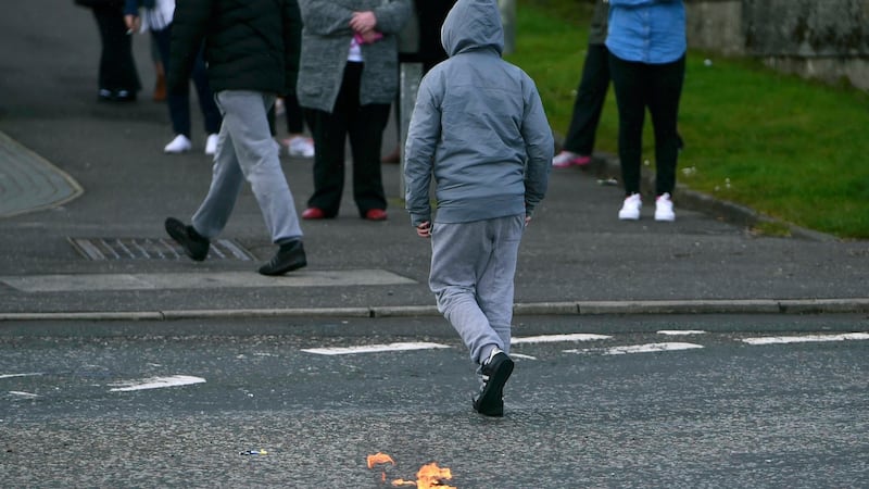 A boy walks away after throwing a petrol bomb ahead of  a 32 County Sovereignty Movement parade in Derry, Easter Monday, 2016.  Photograph: Clodagh Kilcoyne/Reuters