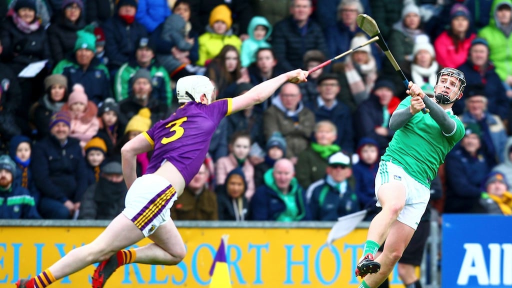 Limerick’s Peter Casey shoots under pressure from Liam Ryan of Wexford during the Allianz Hurling League Division 1A match at Innovate Wexford Park. Photograph: Ken Sutton/Inpho