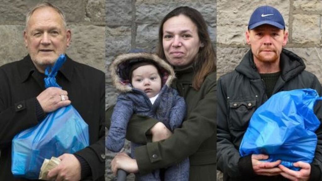 Denis Cowap, Mariana Varvara and her baby Luca, and Stuart Comerford after collecting food parcels from the Capuchin Day Centre, Dublin. Photograph: Dara Mac Dónaill/The Irish Times