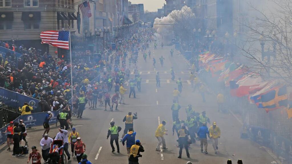 Smoke is seen in the background at the finish line of the Boston Marathon. Photograph: David L. Ryan/The Boston Globe
