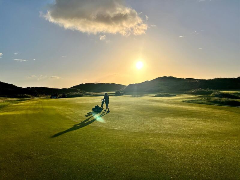 A greenkeeper at work at Royal County Down in the early morning. Photograph: Jerry Scullion/Royal County Down