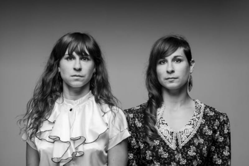 Sisters Megan and Jessica Kennedy of Junk Ensemble in conversation with other artists at Rua Red Gallery.