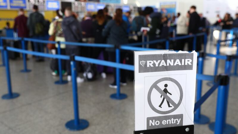 Travellers queue at a Ryanair customer service desk at Stansted. Photograph: Neil HalL/EPA