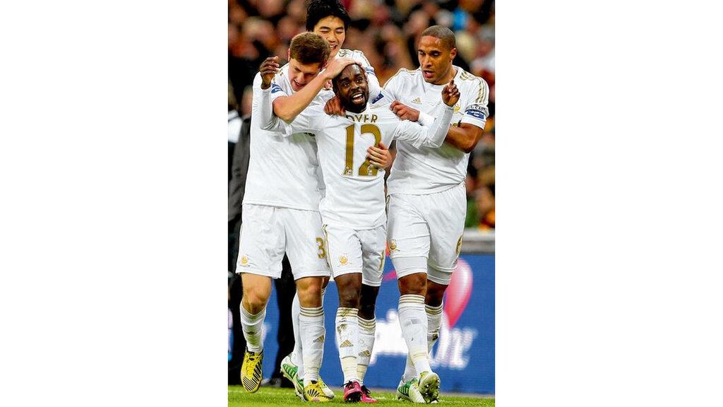Nathan Dyer of Swansea City celebrates with his team- mates after scoring the opening goal in yesterday's victory over Bradford City.photograph: Photograph Scott Heavey/Getty Images