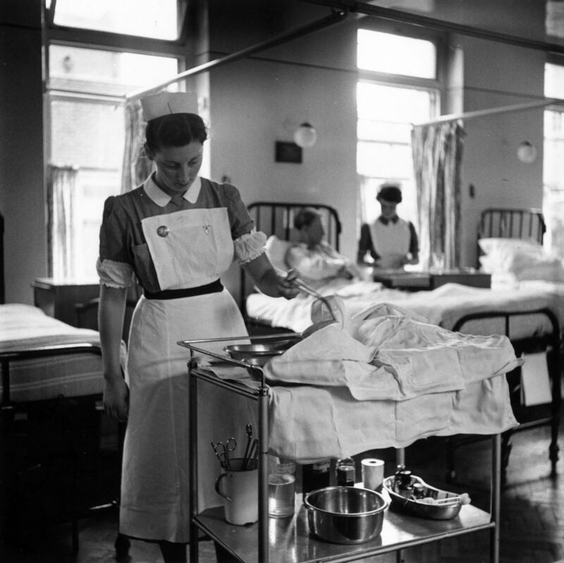 8th October 1954: An Irish nurse at work in a British hospital. Original Publication: Picture Post - 8041 - Why Do These Girls Leave Home? - pub. 1955 (Photo by Raymond Kleboe/Picture Post/Hulton Archive/Getty Images)