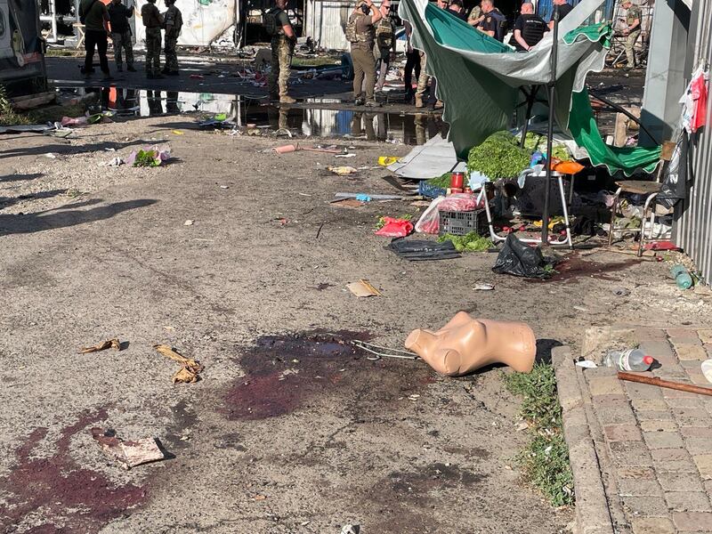 Ukrainian servicemen and rescuers are seen in the aftermath of the Russian strike on Kostiantynivka, Ukraine, on Wednesday. Photograph: AFP via Getty Images