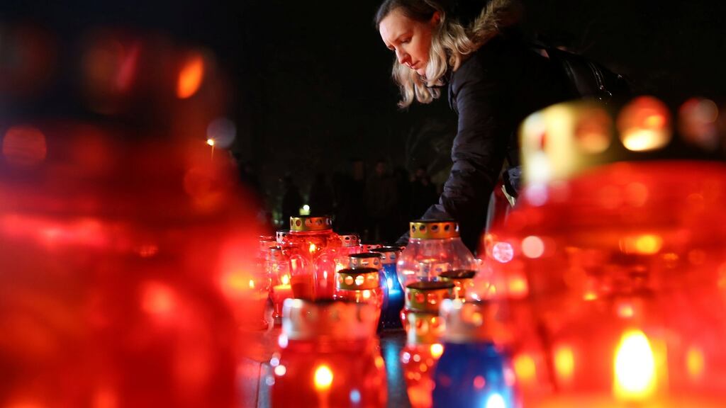 A Bosnian Croat woman lights a candle for convicted general Slobodan Praljak, who killed himself seconds after the verdict in the UN war crimes tribunal in The Hague, in Mostar, Bosnia and Herzegovina. Photograph: Dado Ruvic/Reuters